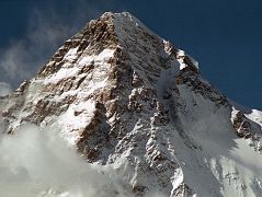 
The K2 West Face shines in the late afternoon sun from Concordia. The K2 West Ridge is on the far left. The Southwest Pillar separates the sunny west face from the K2 South Face. The Great Serac is just in shadow to the right below the K2 Summit. The K2 Shoulder is farther down to the right, partially in the sun. The K2 West Ridge was first climbed by Japanese Eiho Otani and Pakistani Nazir Sabir, reaching the K2 summit on August 7, 1981.
